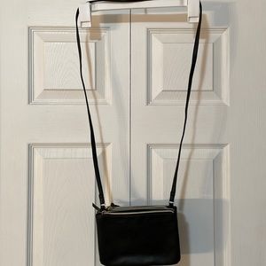 Black faux leather multi-pocket purse.